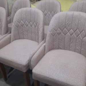 Upholstered dining or accent chairs with a soft, contemporary-classic design