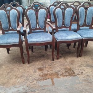 Classic wooden dining chairs with upholstered seats and backs.